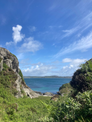 Iona: view of the sea from a beach, rocks on either side of the view